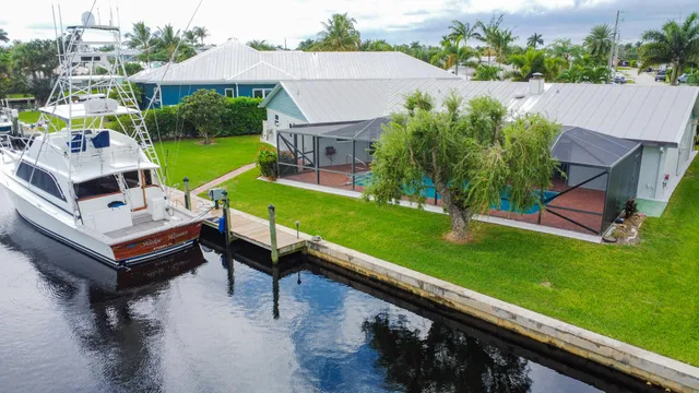 an aerial view of a house with a garden and swimming pool