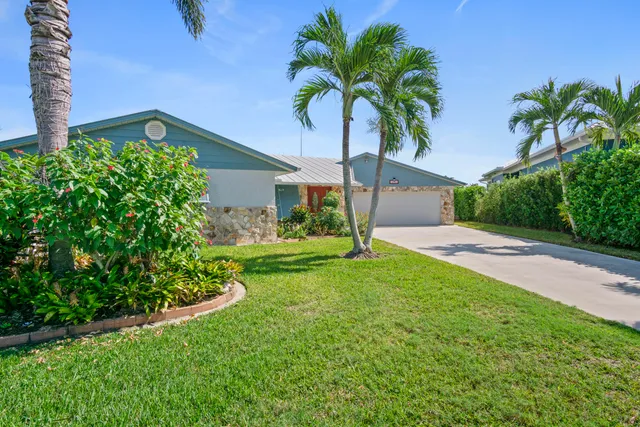 a living room with furniture a chandelier and a large window
