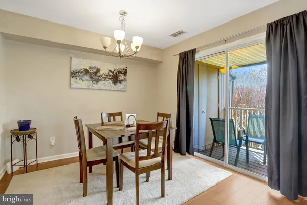 a view of a dining room with furniture and a chandelier