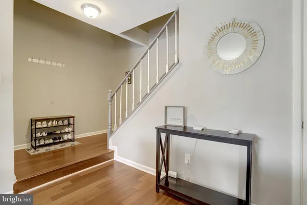 a view of entryway and hall with wooden floor