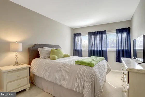 a bedroom with a bed and a night stand