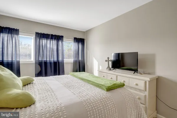 a bedroom with a bed and a flat screen television