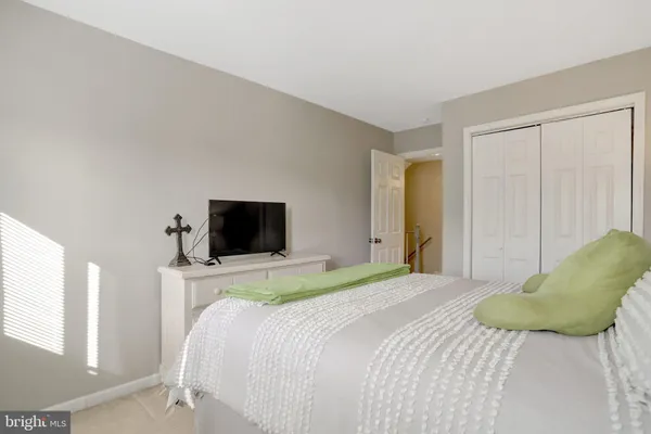 a bedroom with a bed and a television
