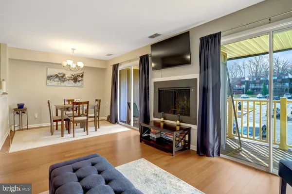 a living room with furniture a fireplace and a large window