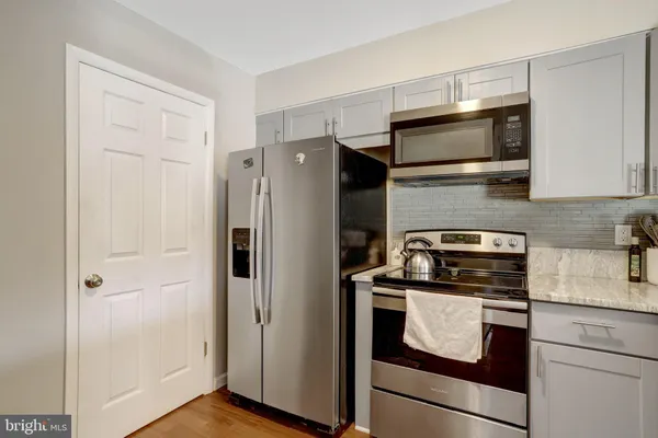 a kitchen with a refrigerator stove and microwave