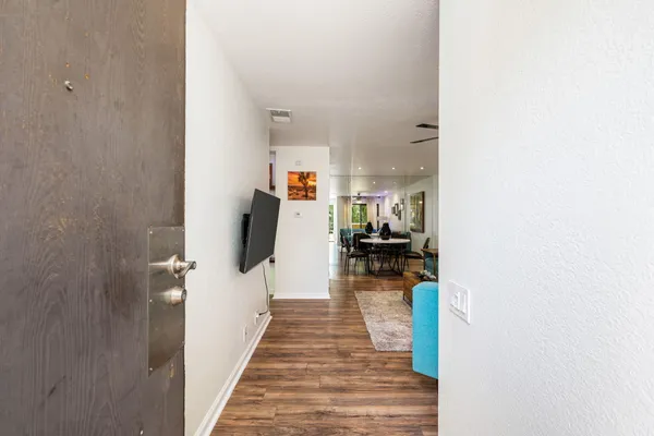 a hallway with a view of bedroom and living room