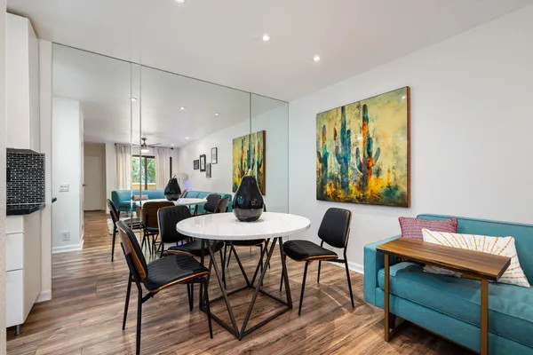 a view of a dining room with furniture and wooden floor