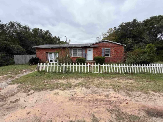 a view of a wooden fence next to a yard