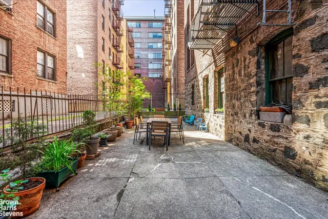 a view of a patio with table and chairs and potted plants