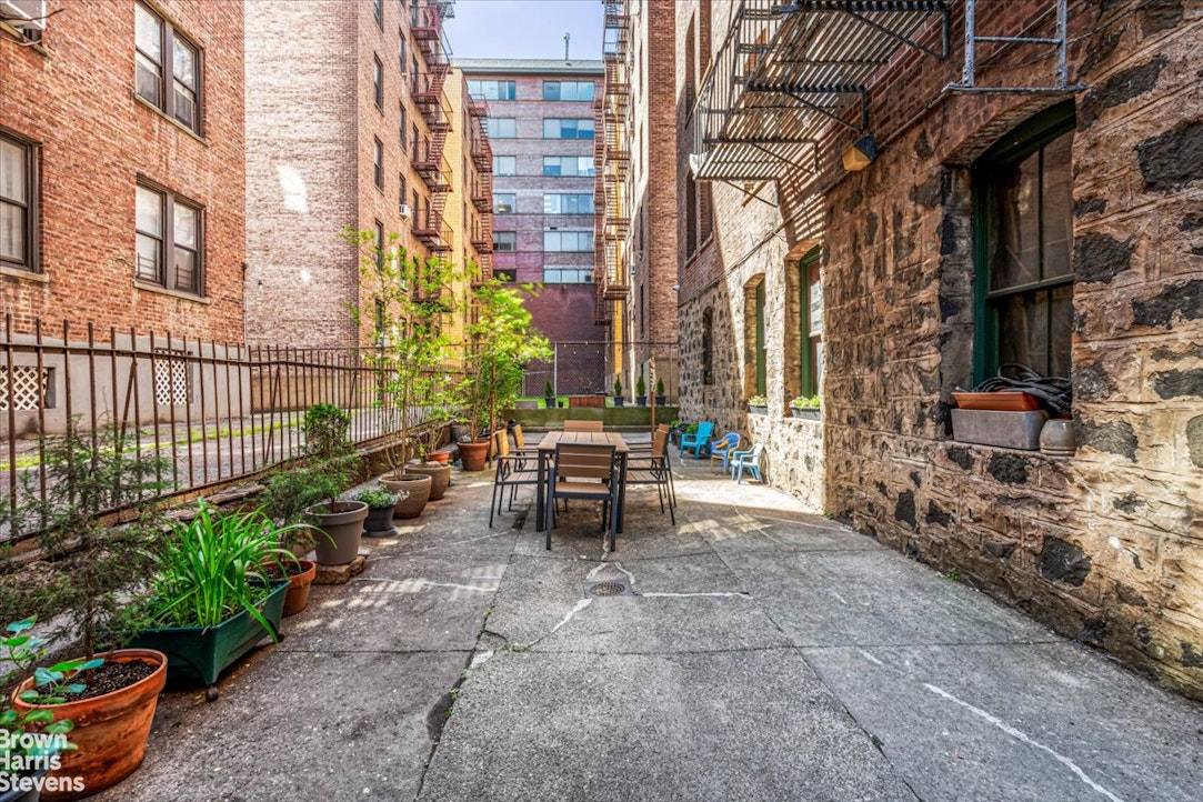 35-45 82nd Street, Unit 4 Queens, NY 11372 - Photo 13 of 15 a view of a patio with table and chairs and potted plants