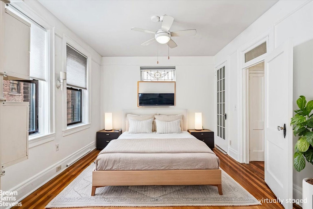 35-45 82nd Street, Unit 4 Queens, NY 11372 - Photo 3 of 15 a bedroom with a large bed and a chandelier