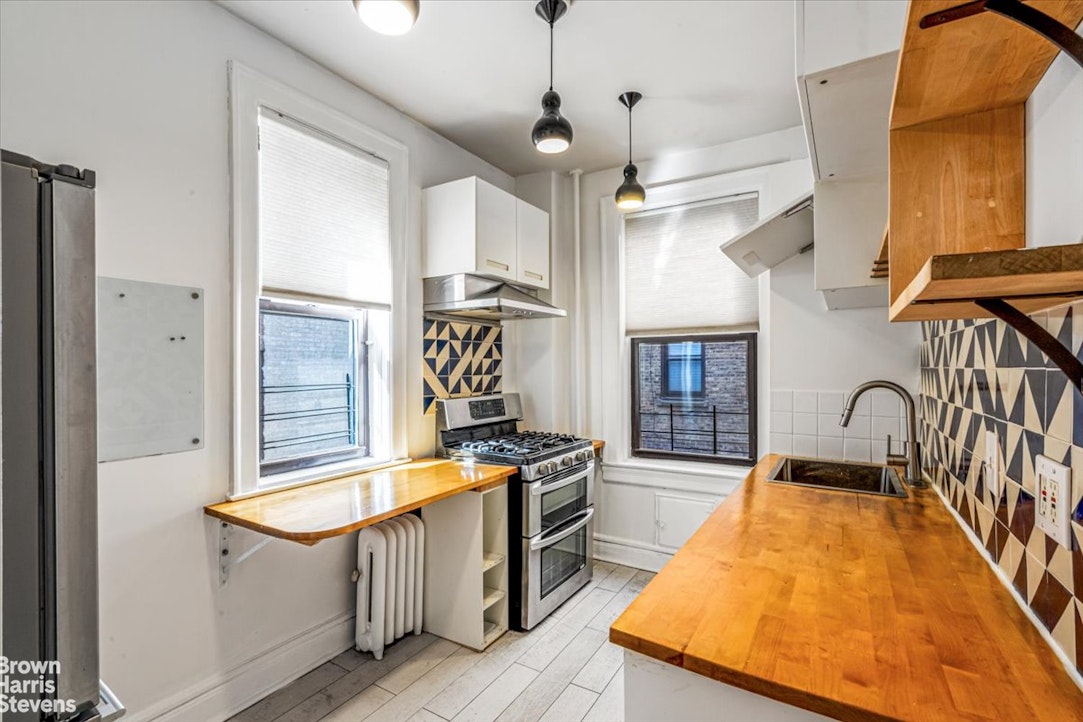 35-45 82nd Street, Unit 4 Queens, NY 11372 - Photo 5 of 15 a kitchen with stainless steel appliances granite countertop a sink a stove and a refrigerator