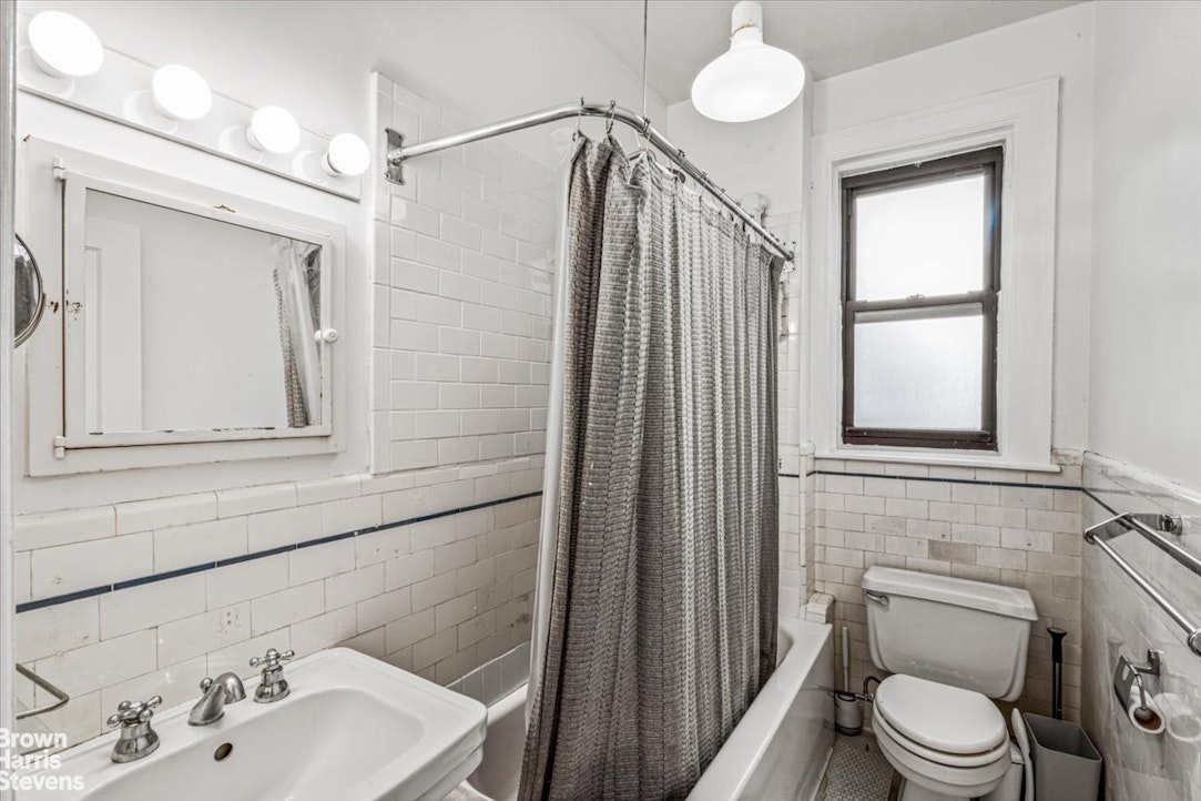 35-45 82nd Street, Unit 4 Queens, NY 11372 - Photo 9 of 15 a bathroom with a sink a toilet and shower