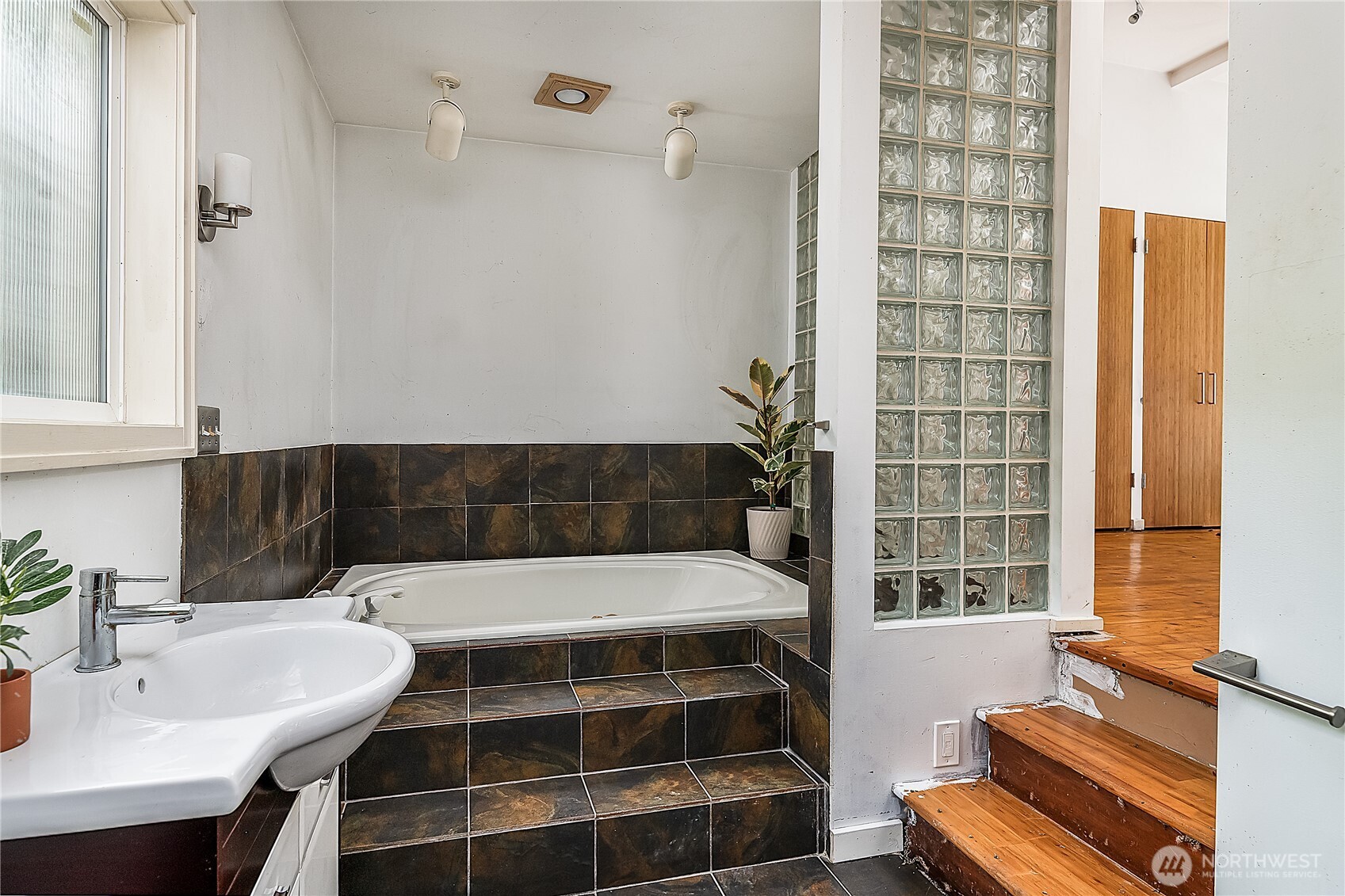 9521 25th Avenue Northwest Seattle, WA 98117 - Photo 13 of 29 a bathroom with a bathtub and a sink
