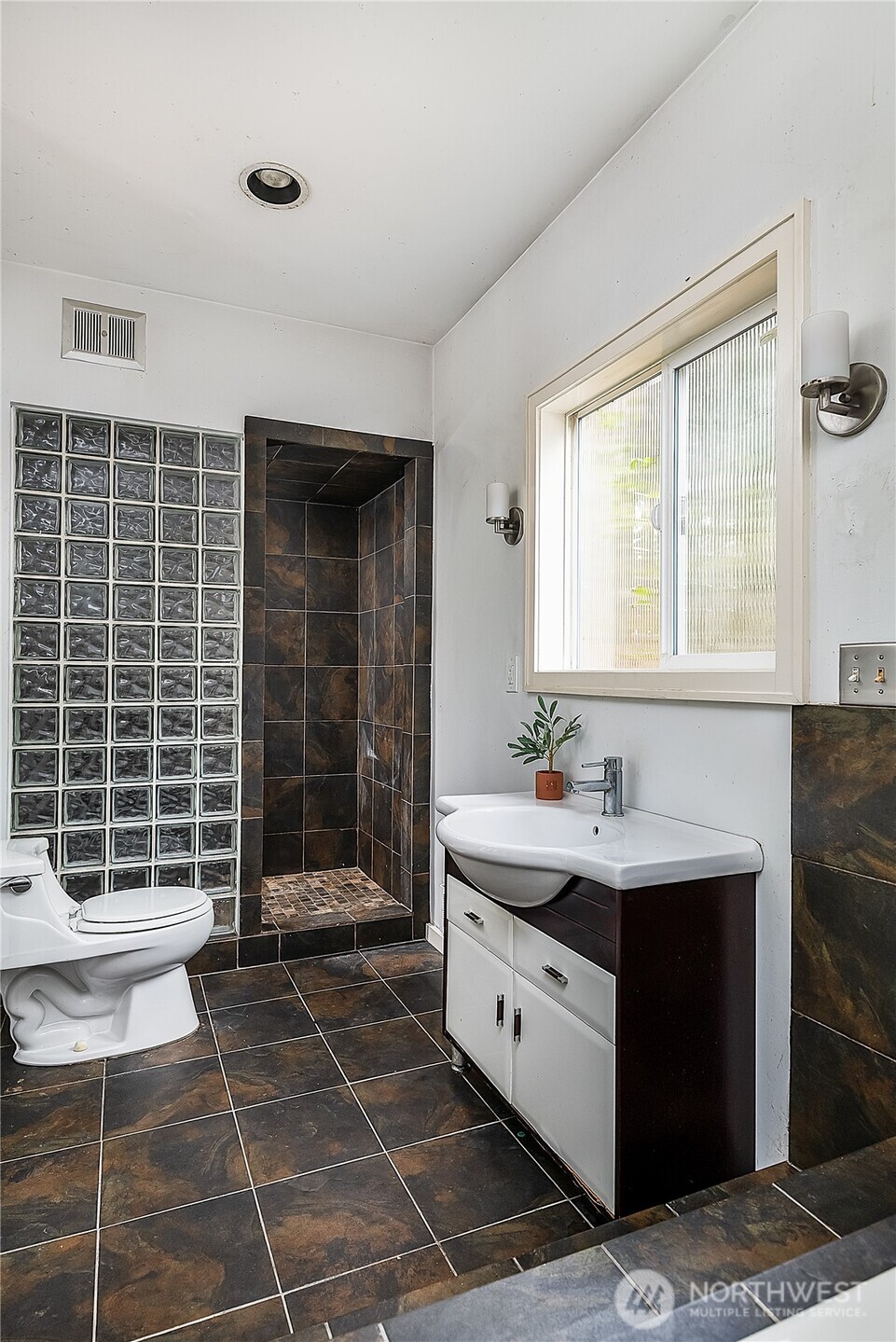9521 25th Avenue Northwest Seattle, WA 98117 - Photo 14 of 29 a bathroom with a sink a toilet and shower