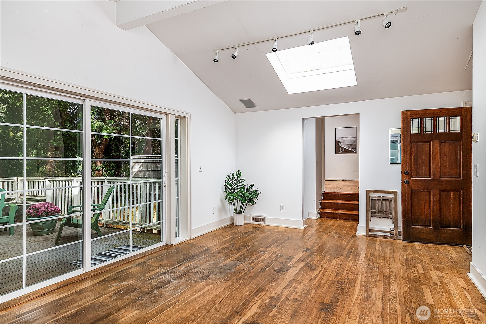 9521 25th Avenue Northwest Seattle, WA 98117 - Photo 16 of 29 a view of empty room with wooden floor and windows