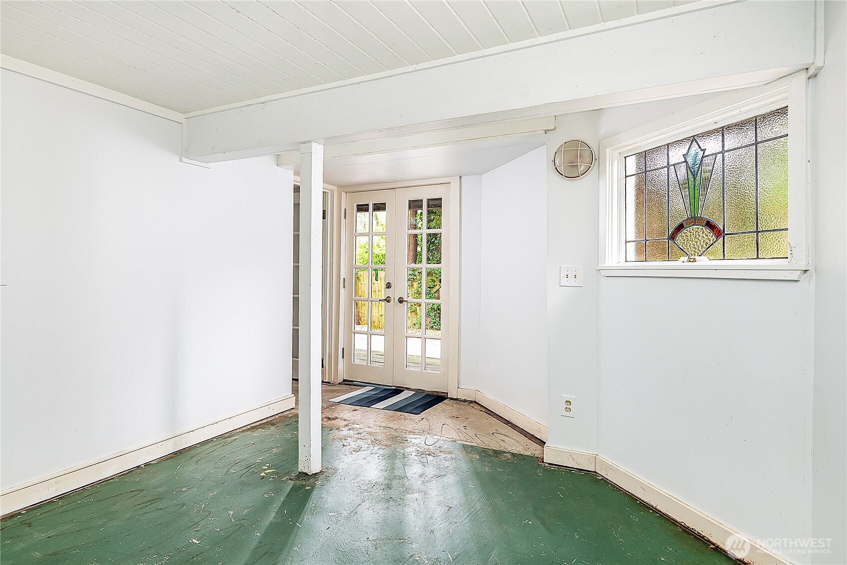 9521 25th Avenue Northwest Seattle, WA 98117 - Photo 19 of 29 an empty room with wooden floor and windows