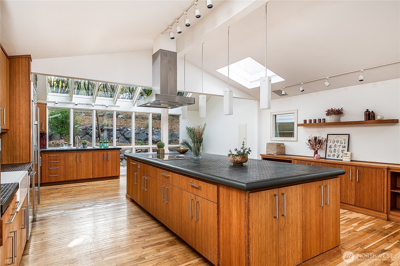 9521 25th Avenue Northwest Seattle, WA 98117 - Photo 2 of 29 a kitchen with stainless steel appliances granite countertop a sink a stove and a wooden floors
