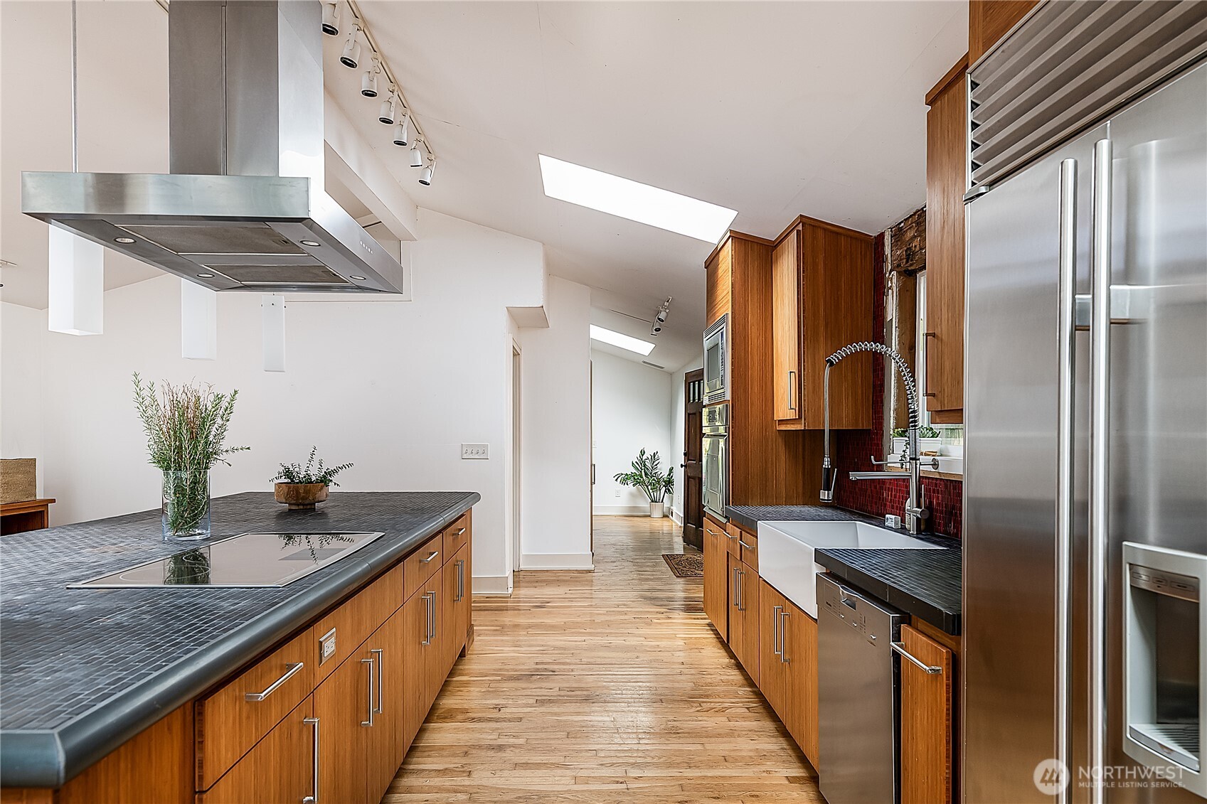 9521 25th Avenue Northwest Seattle, WA 98117 - Photo 6 of 29 a kitchen with stainless steel appliances granite countertop a sink a stove and a refrigerator