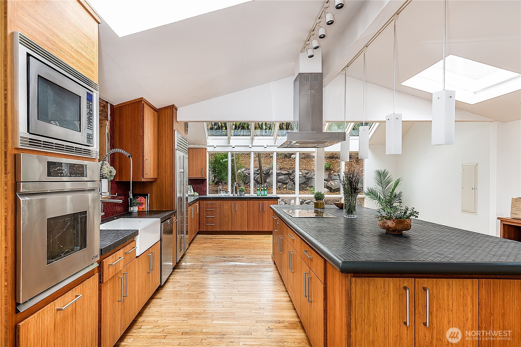 9521 25th Avenue Northwest Seattle, WA 98117 - Photo 8 of 29 a kitchen with stainless steel appliances granite countertop a sink and a refrigerator