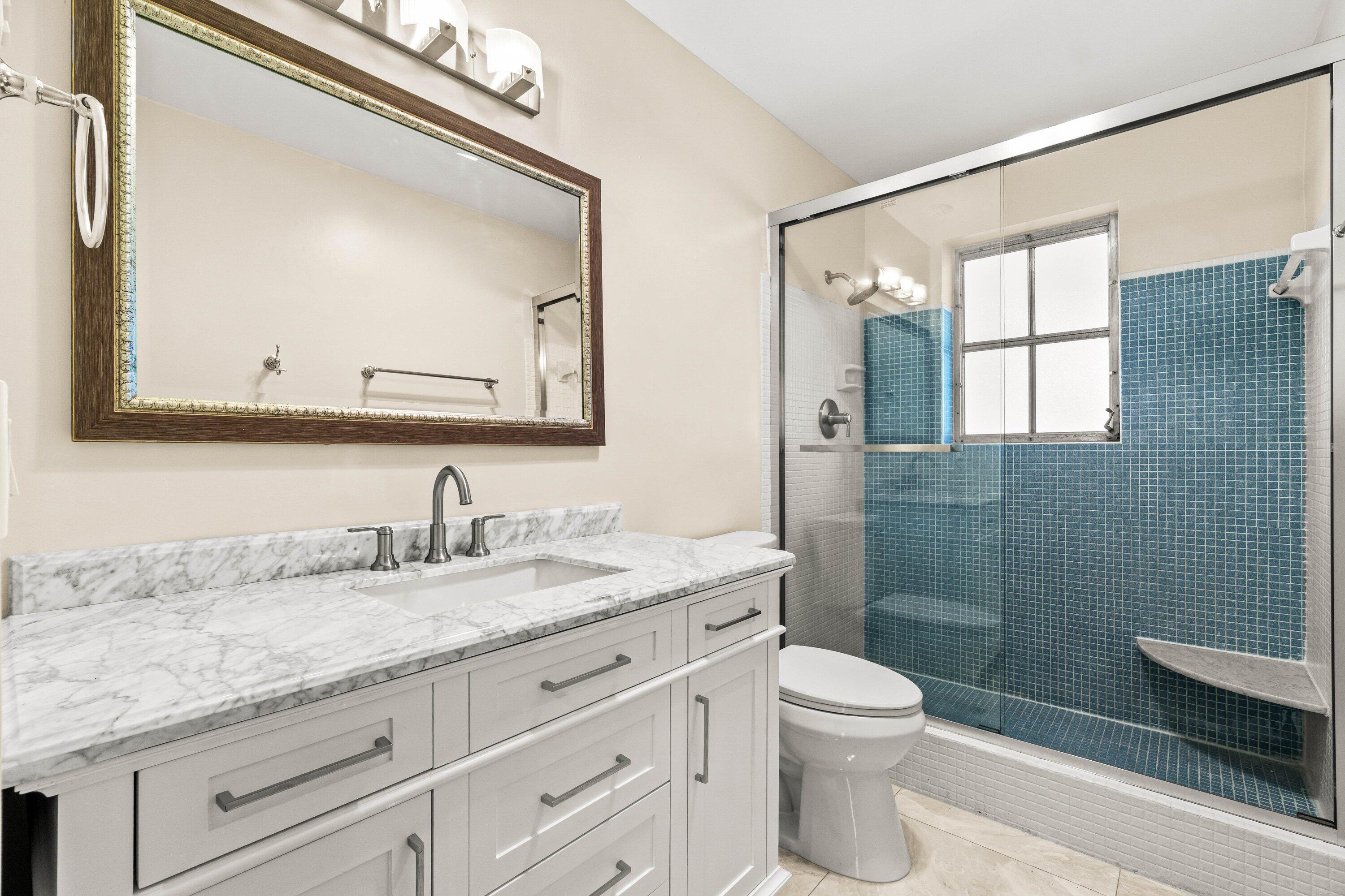 1290 Southwest 8th Street Boca Raton, FL 33486 - Photo 15 of 29 a bathroom with a granite countertop sink toilet and shower