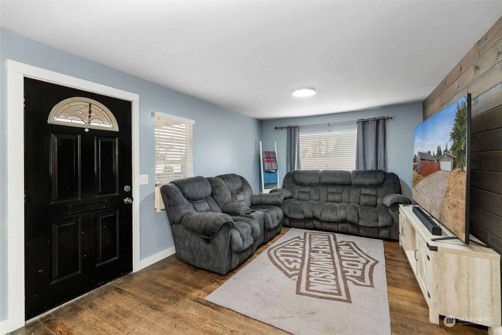 2711 Maple Street Bremerton, WA 98310 - Photo 11 of 23 a living room with furniture a flat screen tv and a refrigerator