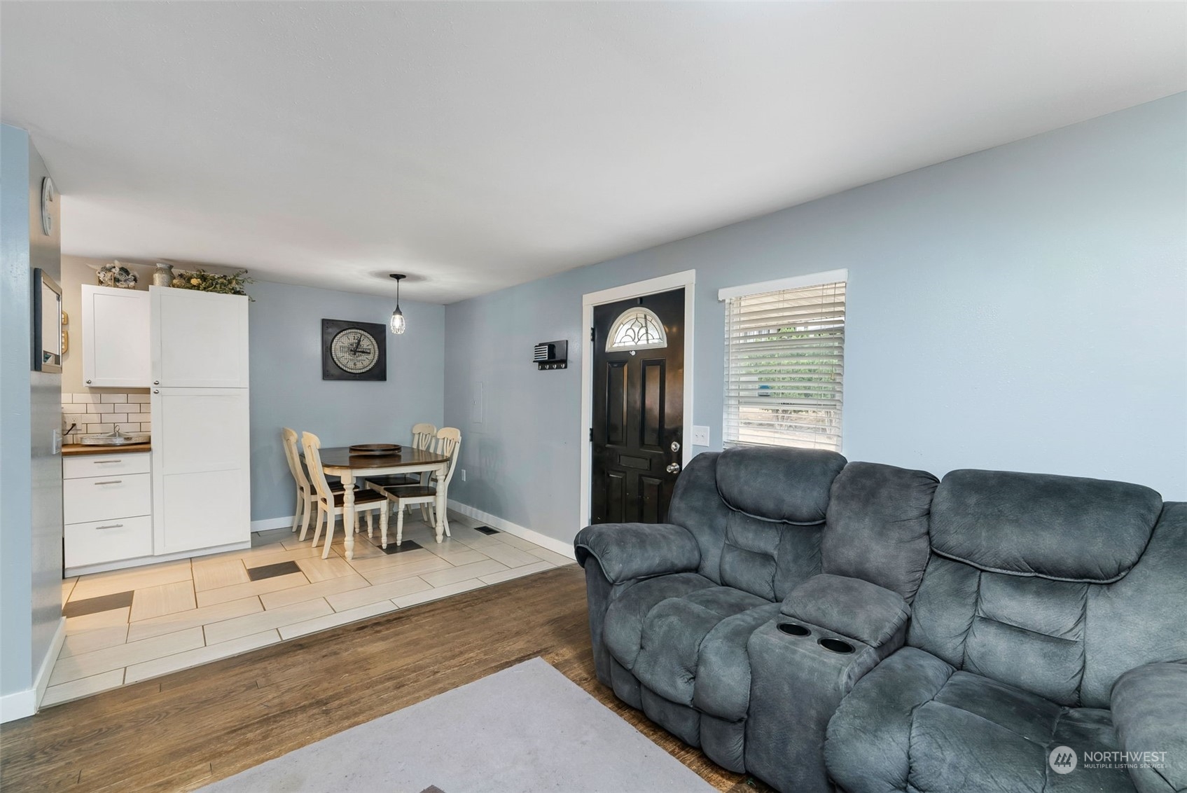 2711 Maple Street Bremerton, WA 98310 - Photo 12 of 23 a living room with furniture and a dining table with wooden floor