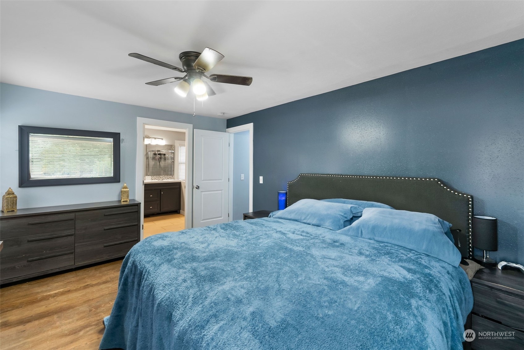 2711 Maple Street Bremerton, WA 98310 - Photo 13 of 23 a bedroom with a large bed and a chandelier