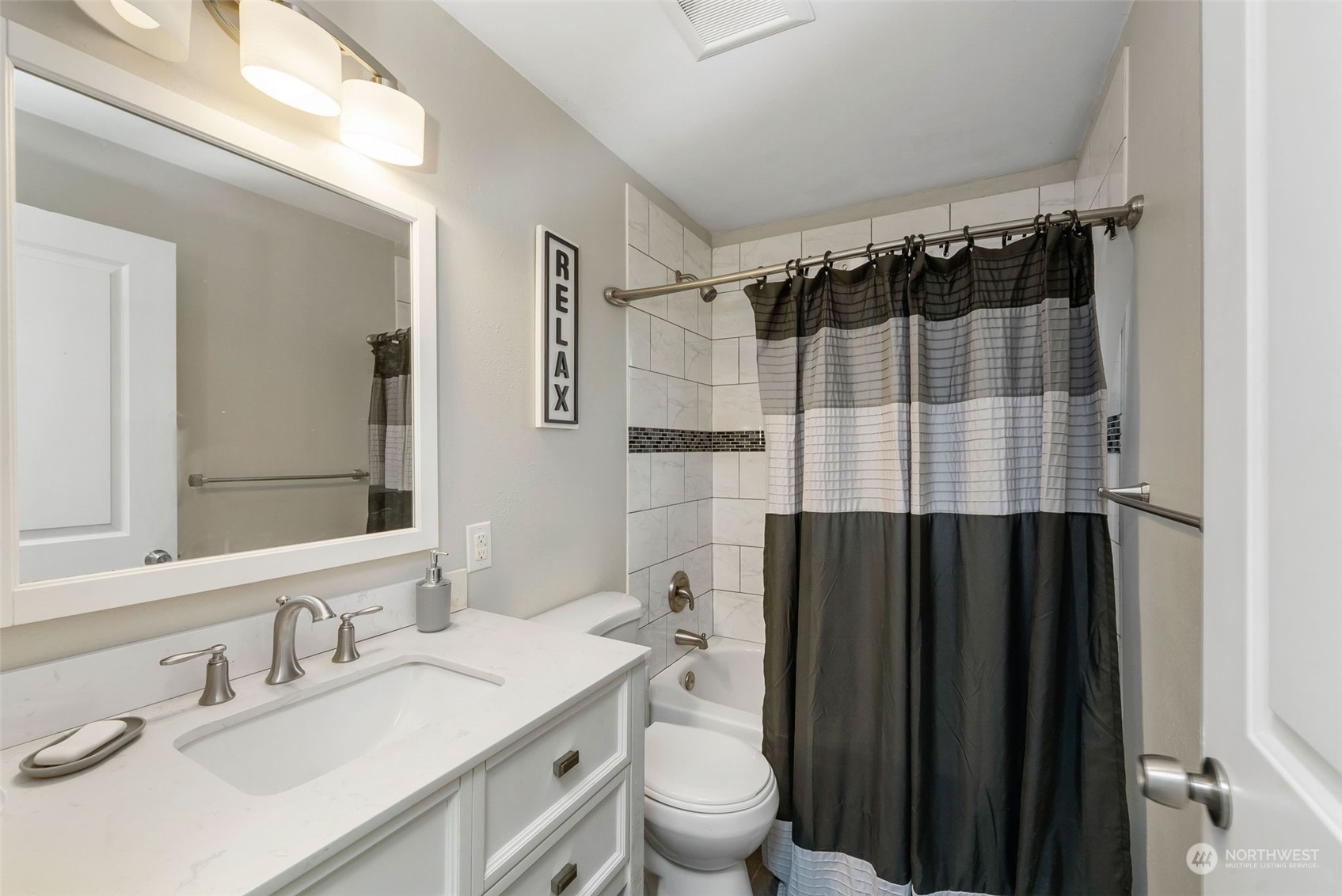 2711 Maple Street Bremerton, WA 98310 - Photo 18 of 23 a bathroom with a sink and a mirror