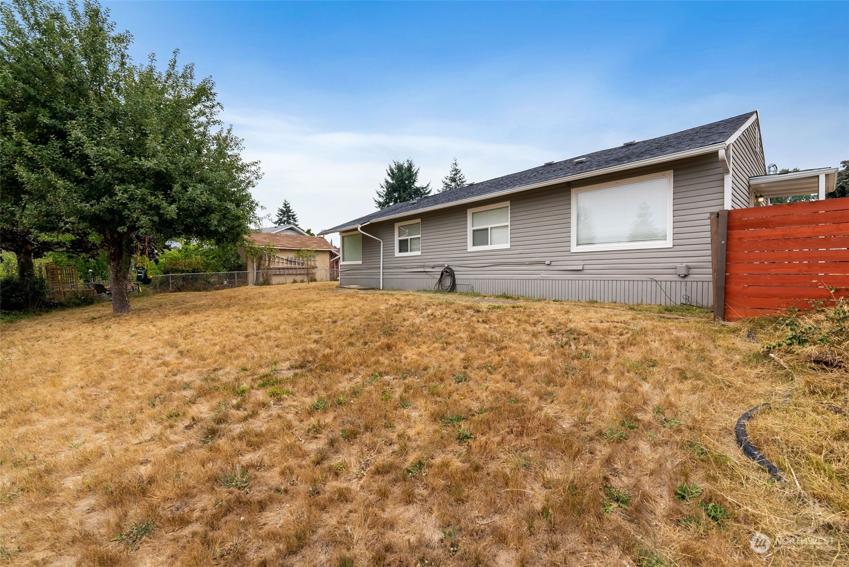 2711 Maple Street Bremerton, WA 98310 - Photo 4 of 23 a house with trees in the background