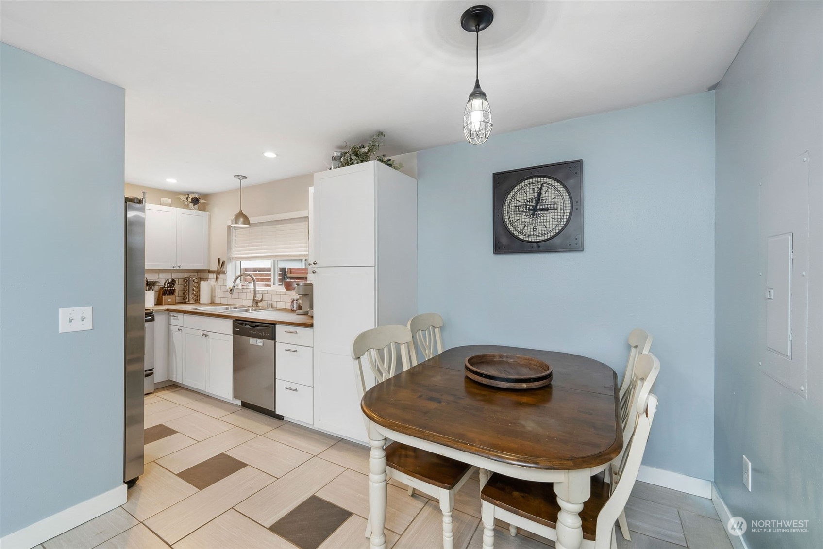 2711 Maple Street Bremerton, WA 98310 - Photo 8 of 23 a kitchen with a table chairs a refrigerator and a stove