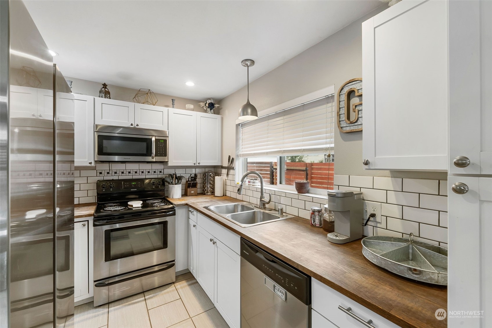 2711 Maple Street Bremerton, WA 98310 - Photo 9 of 23 a kitchen with granite countertop a sink and steel appliances