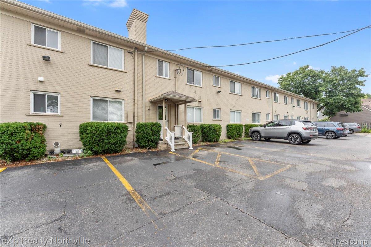 475 South Adams Road Birmingham, MI 48009 - Photo 22 of 23 View of apartment building / complex featuring uncovered parking