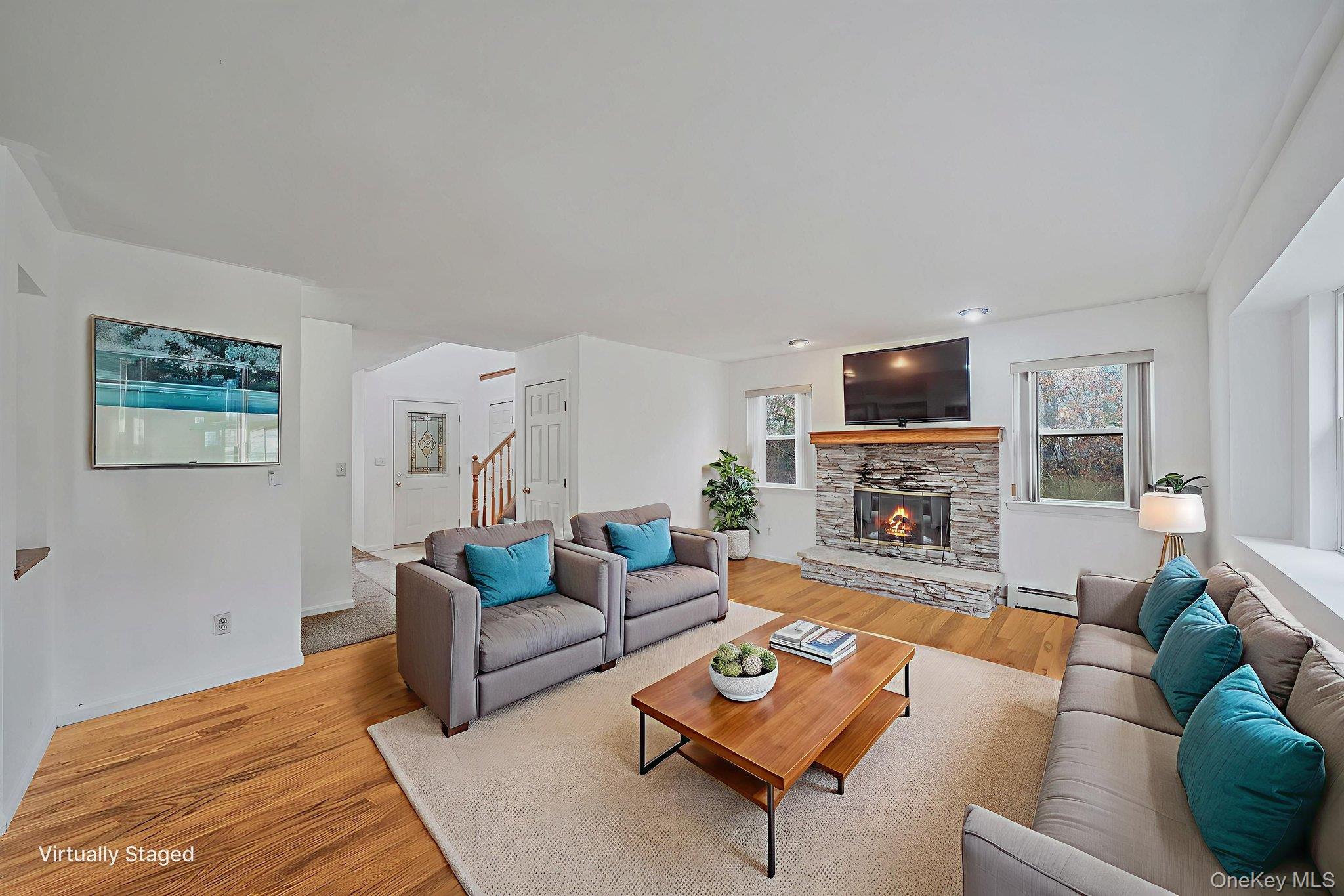 22 Wright Road Manorville, NY 11949 - Photo 11 of 47 a living room with furniture a coffee table a flat screen tv and a window