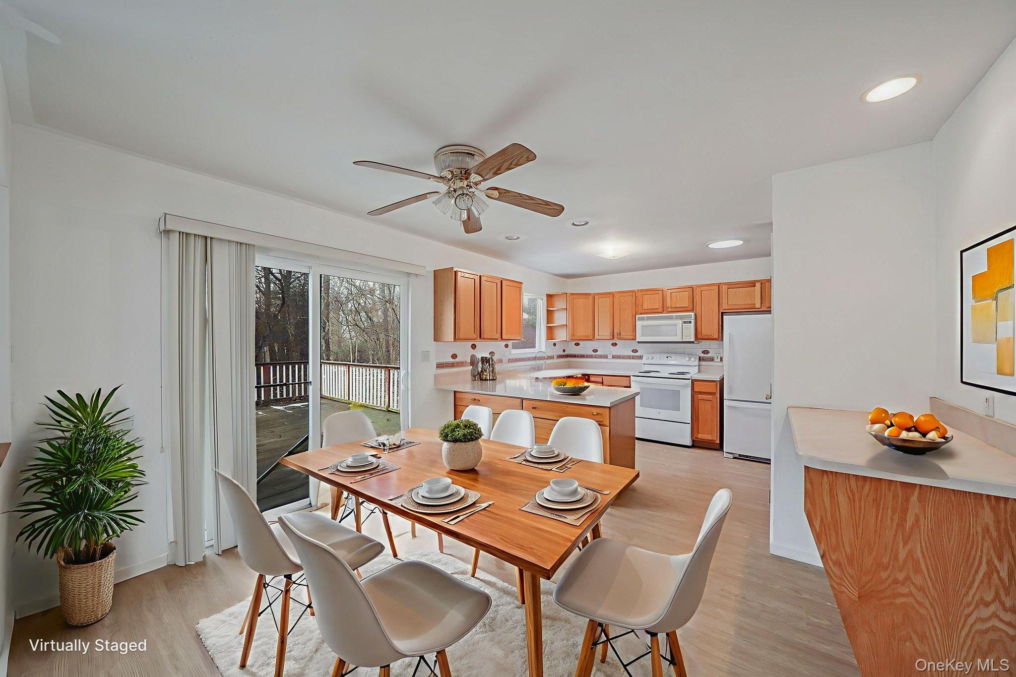 22 Wright Road Manorville, NY 11949 - Photo 16 of 47 a view of a dining room with furniture and a potted plant
