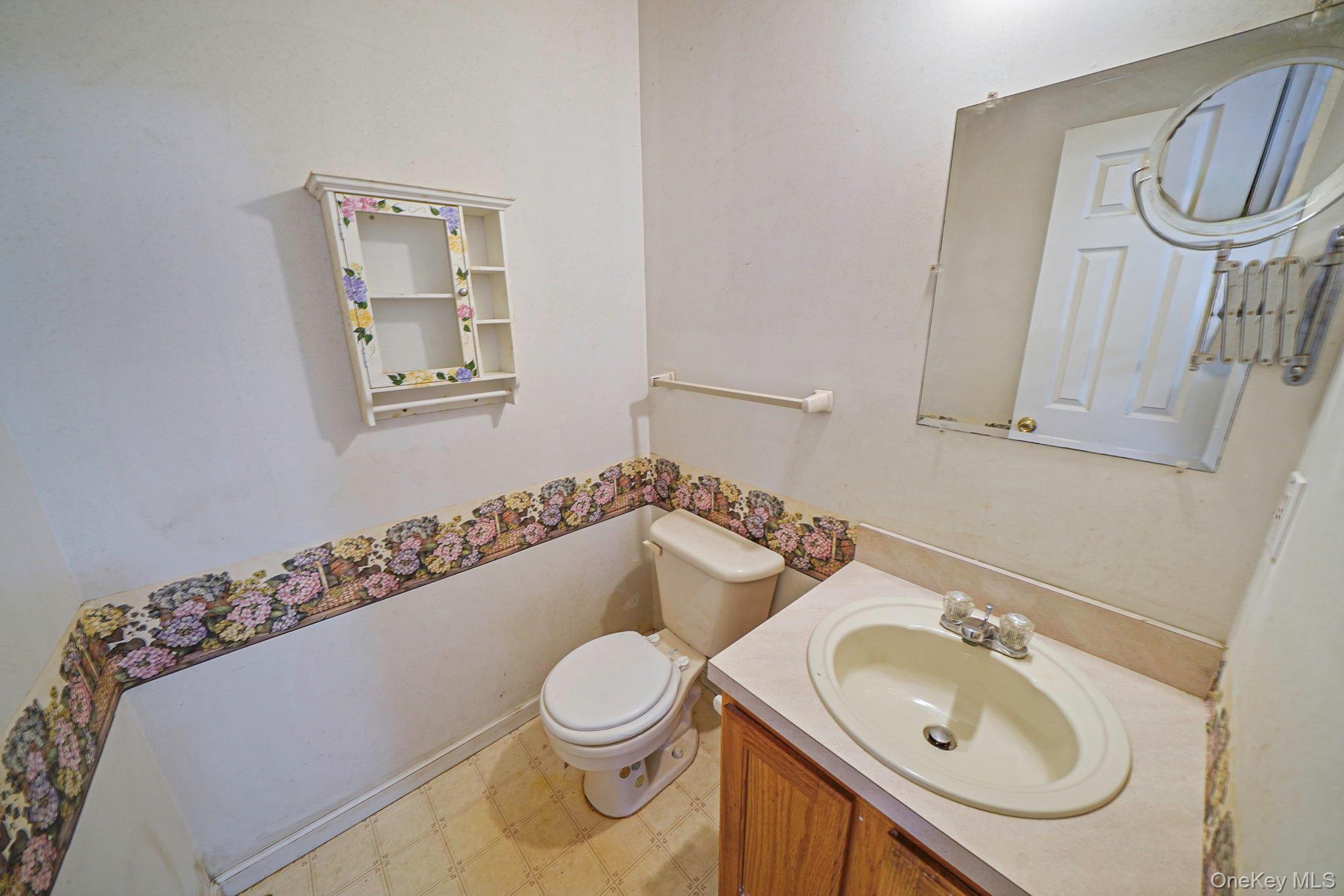 22 Wright Road Manorville, NY 11949 - Photo 17 of 47 a bathroom with a sink a toilet and a mirror