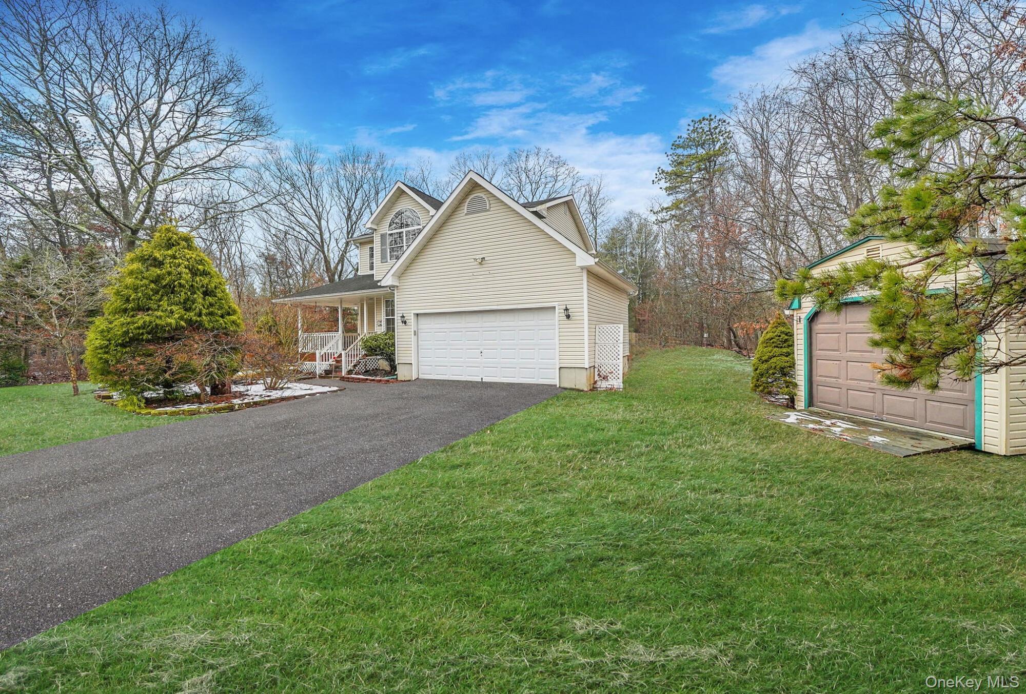 22 Wright Road Manorville, NY 11949 - Photo 2 of 47 a view of a yard in front of a house with large tree
