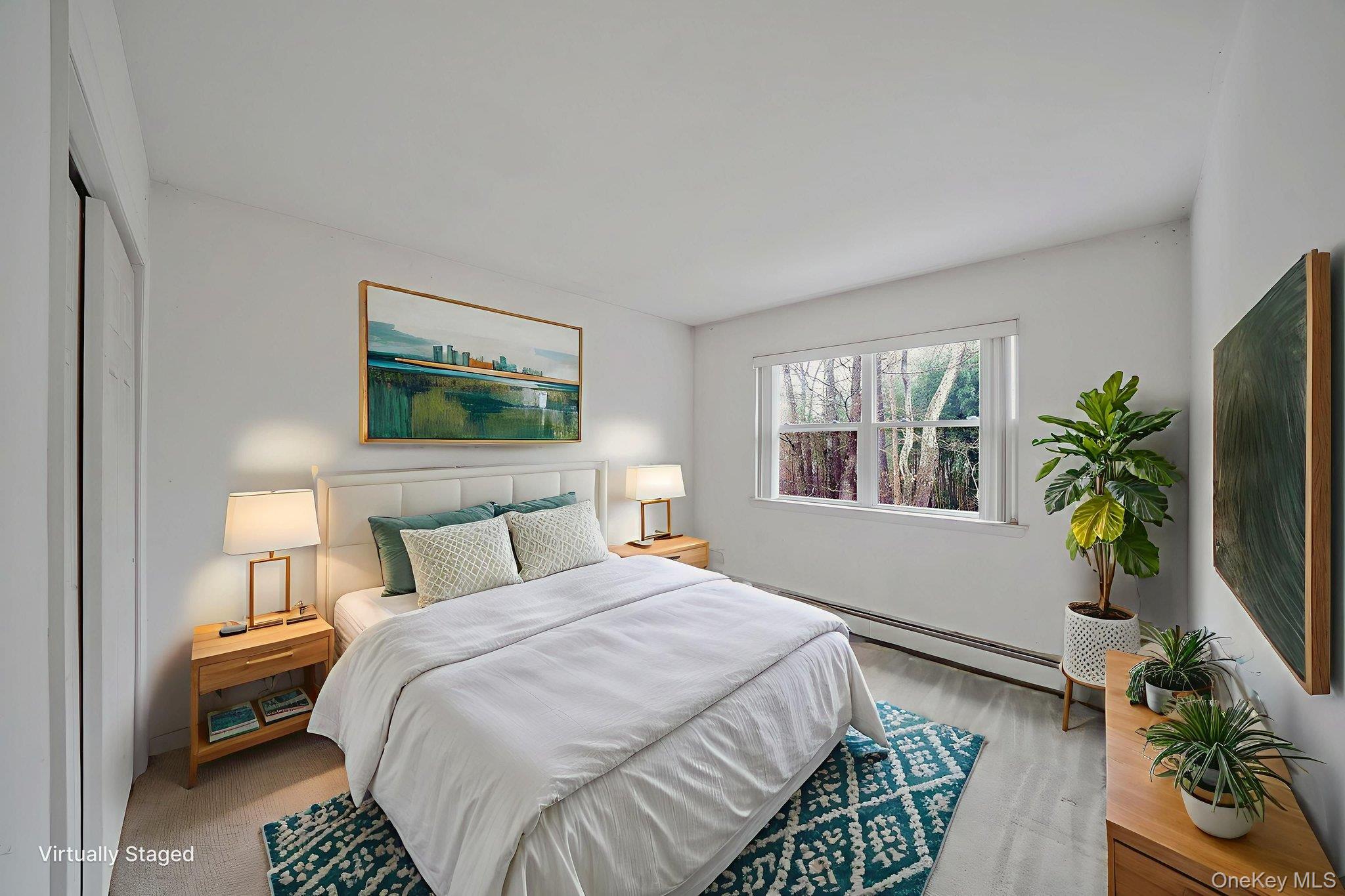 22 Wright Road Manorville, NY 11949 - Photo 25 of 47 a bedroom with a bed window and potted plant on the table