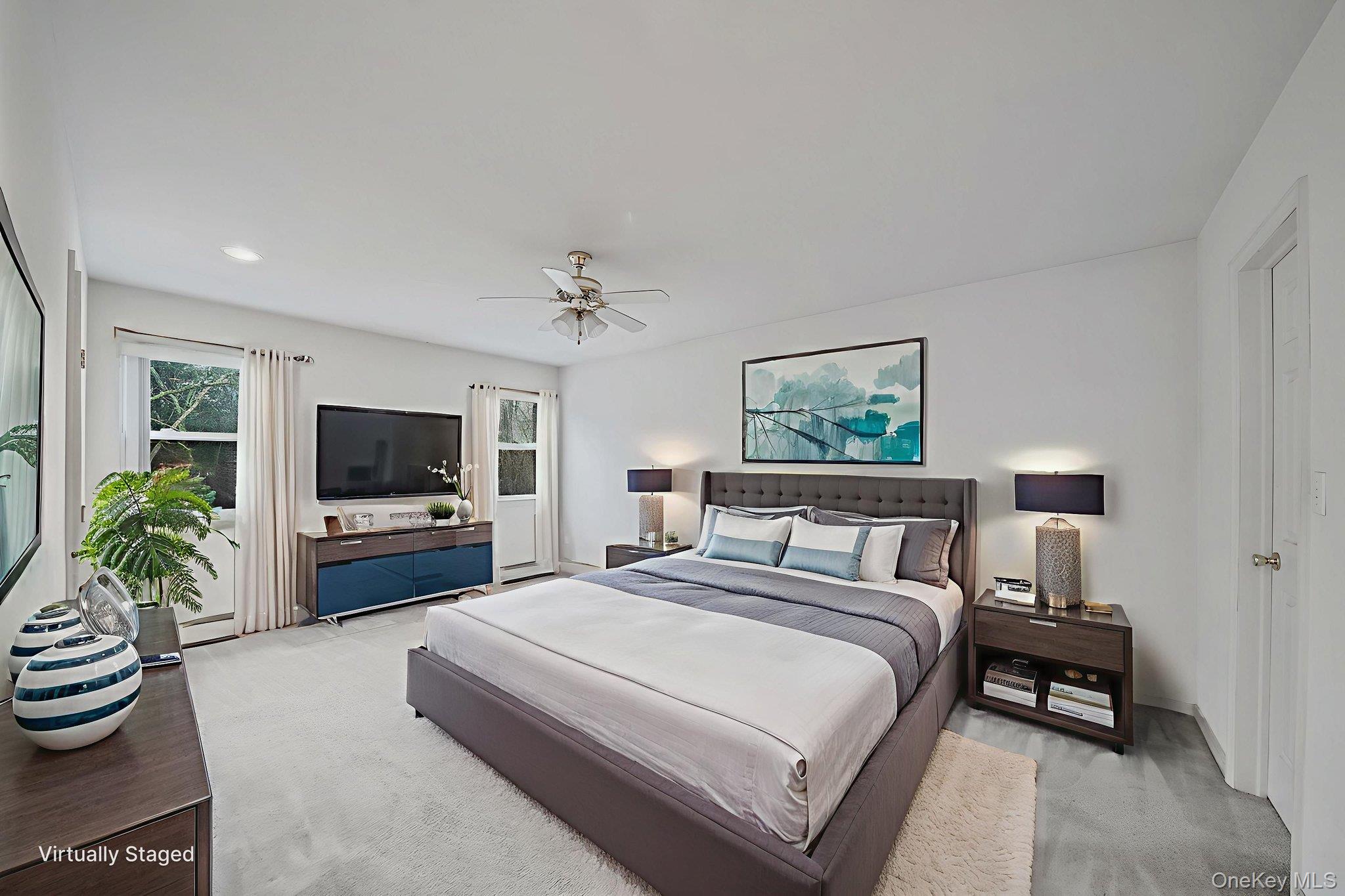 22 Wright Road Manorville, NY 11949 - Photo 28 of 47 a bedroom with a bed and a flat screen tv