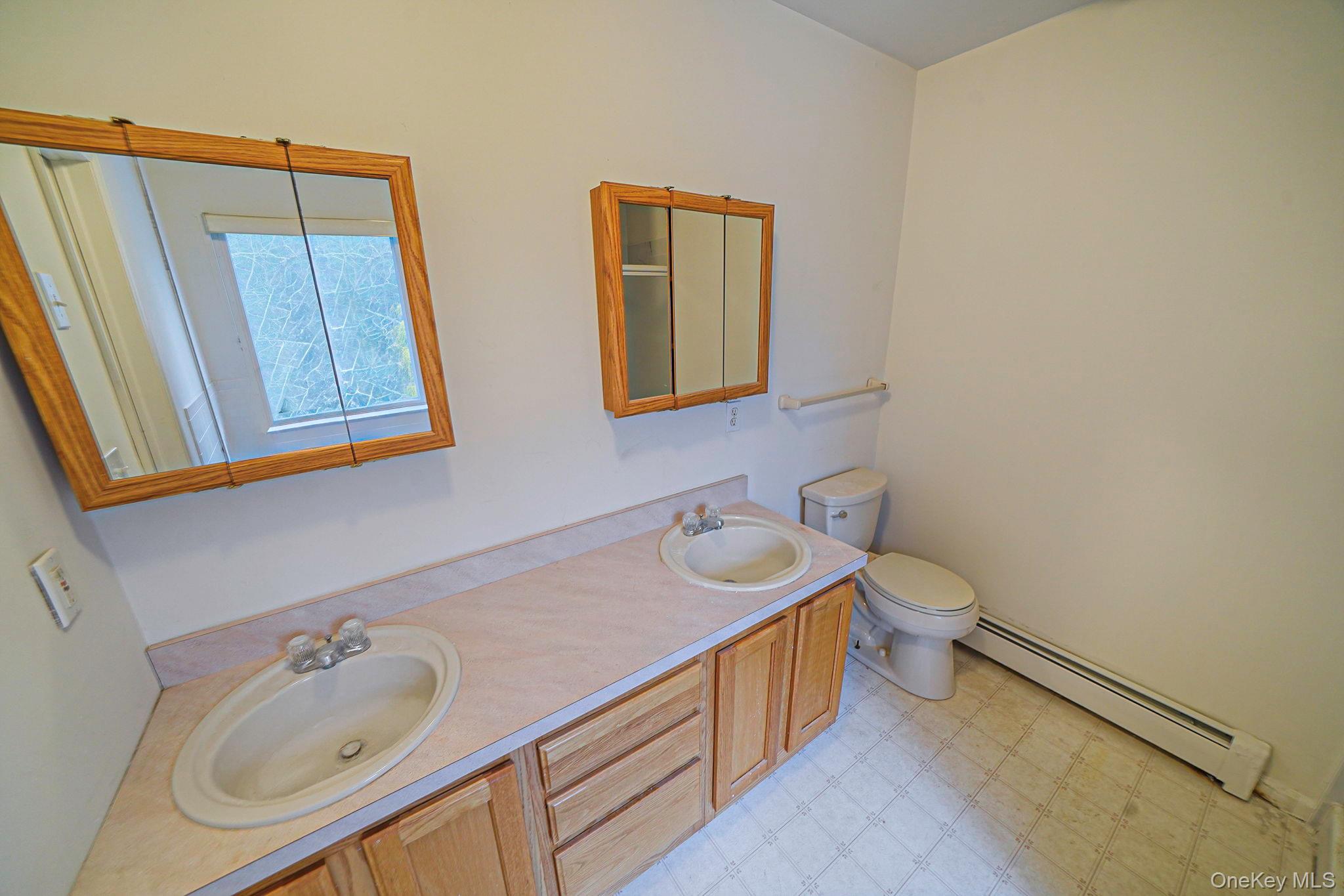 22 Wright Road Manorville, NY 11949 - Photo 30 of 47 a bathroom with a sink and a mirror
