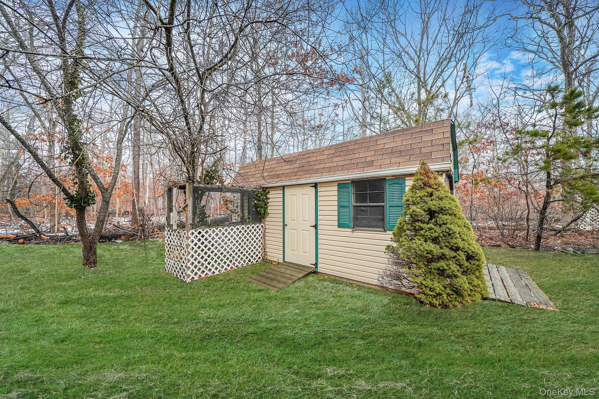 22 Wright Road Manorville, NY 11949 - Photo 35 of 47 a front view of a house with a garden