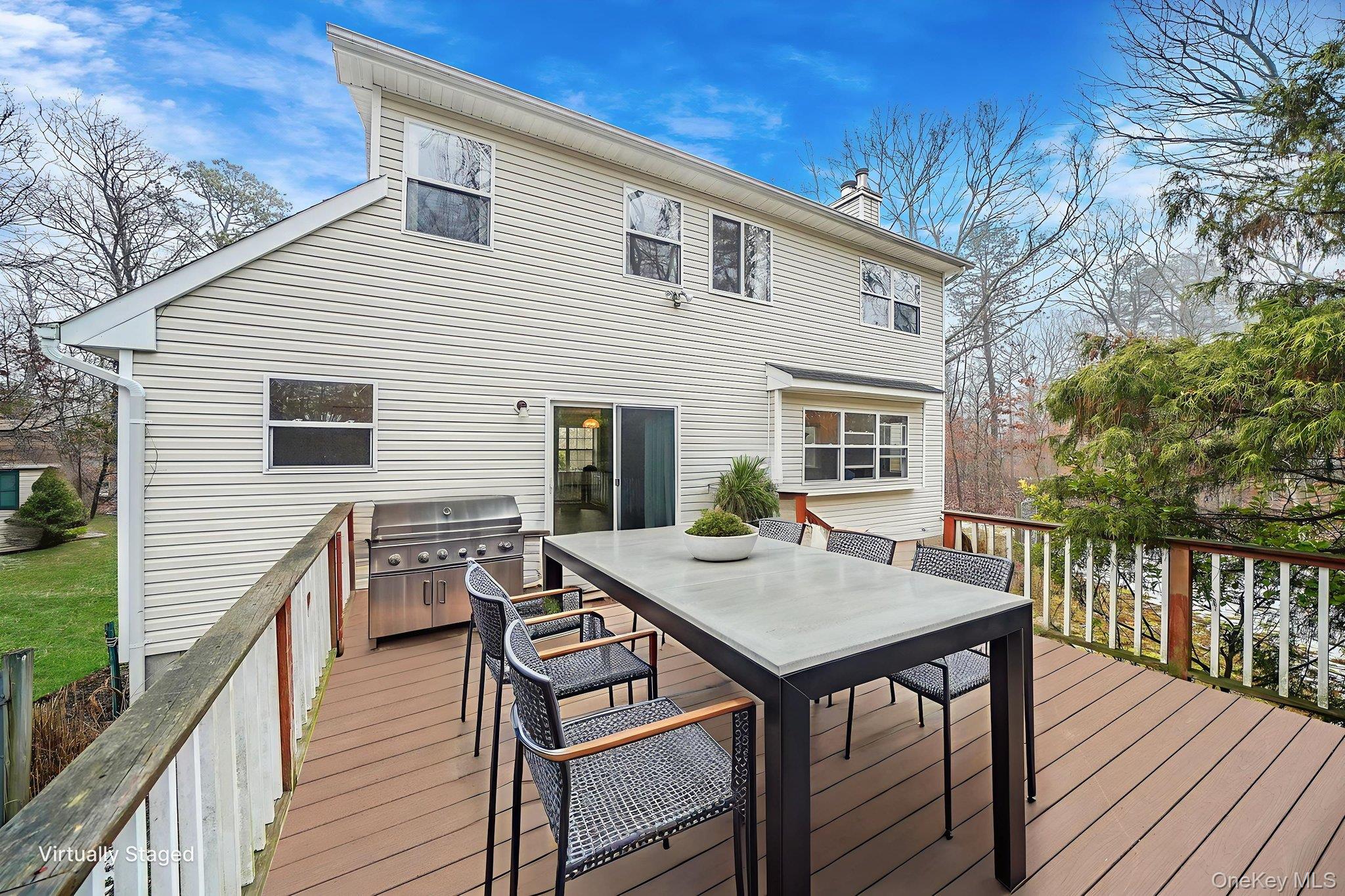 22 Wright Road Manorville, NY 11949 - Photo 36 of 47 a view of a roof deck with table and chairs floor to ceiling window with wooden floor