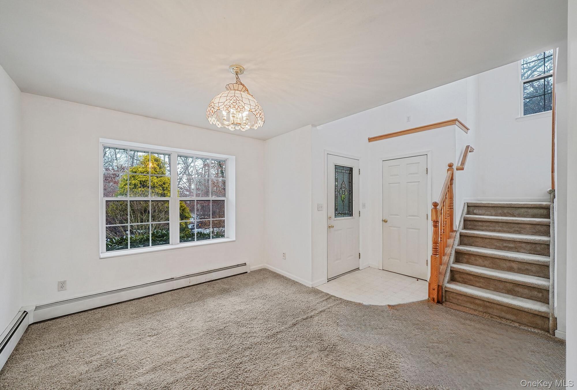 22 Wright Road Manorville, NY 11949 - Photo 4 of 47 a view of an empty room with a window