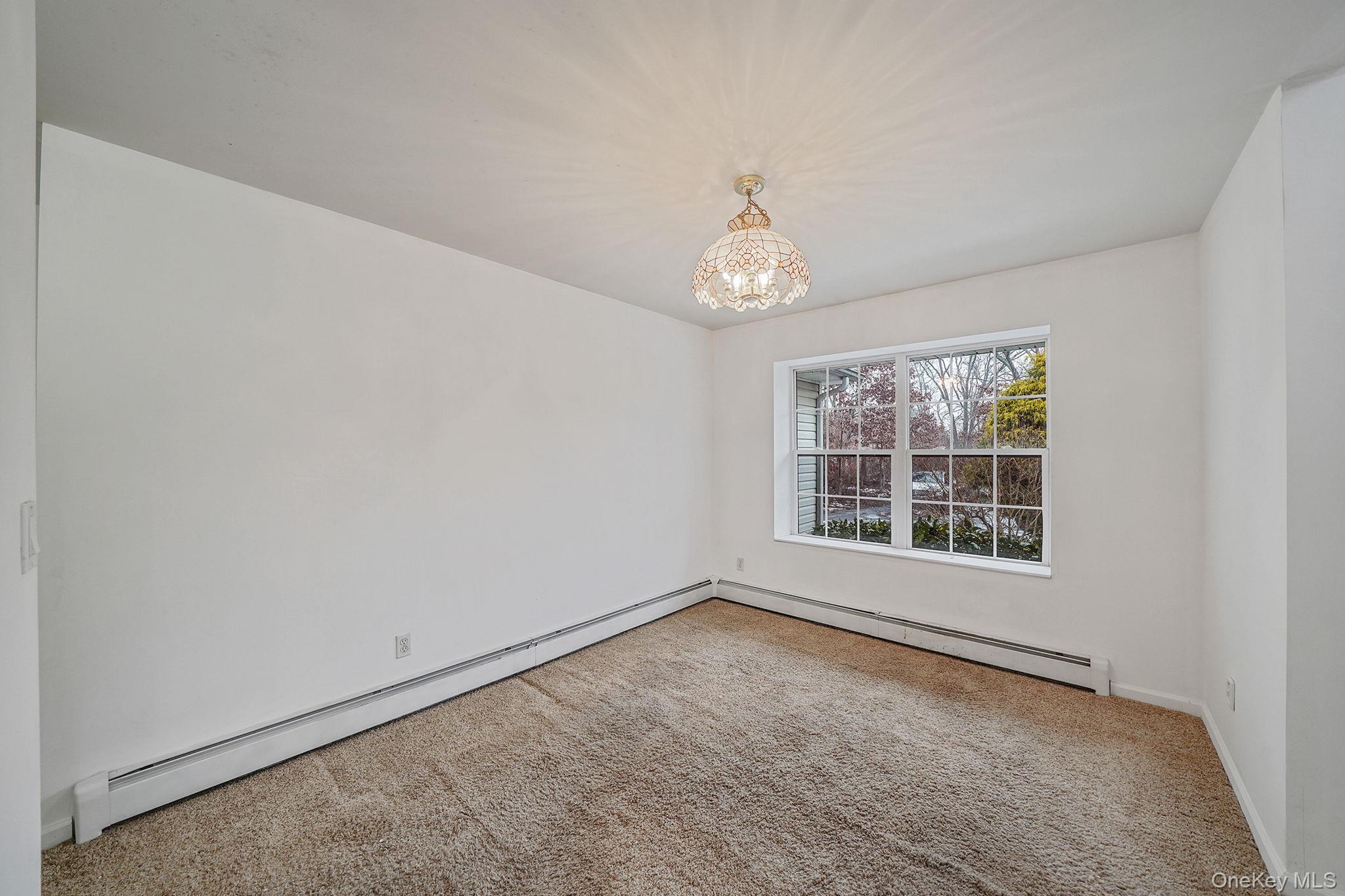 22 Wright Road Manorville, NY 11949 - Photo 6 of 47 an empty room with a window