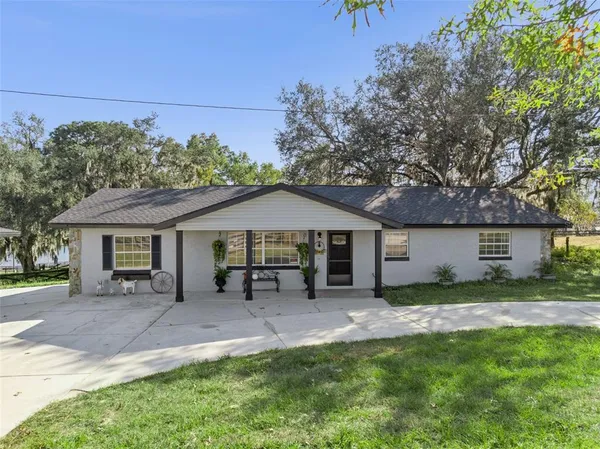 a view of a house with a yard and garage