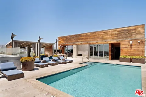 a view of a house with backyard porch and sitting area