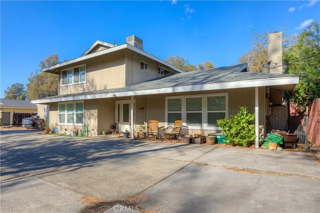 a front view of a house with a garden and porch