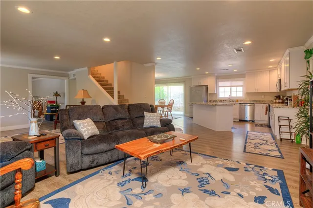 a living room with furniture and kitchen view