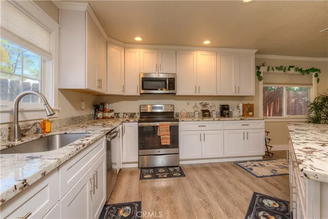 a kitchen with a sink stove and cabinets