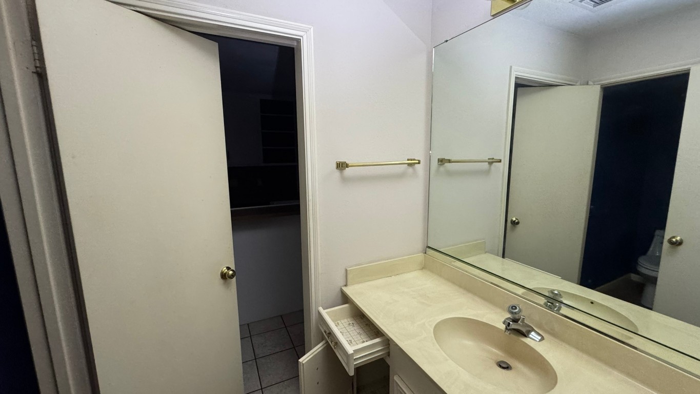 2162 Paso Rello Drive Houston, TX 77077 - Photo 7 of 32 a bathroom with a sink and a mirror